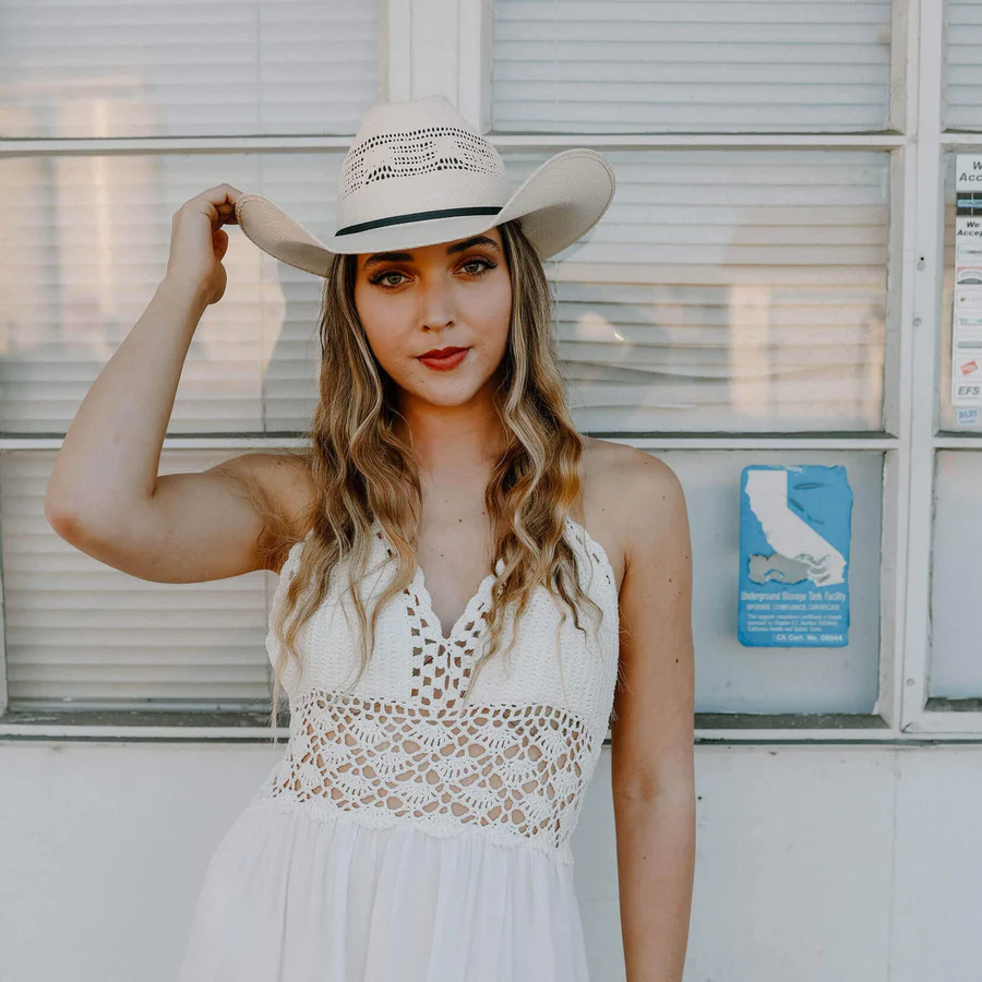 Straw cowboy hat with white mini lace dress