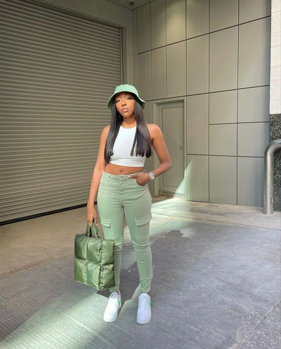 Wearing a bucket hat with a lace-up top, cargo pants, and sneakers