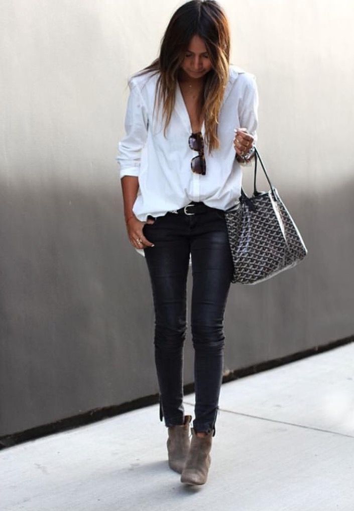 Wearing a white button-down shirt, black leather skinny pants, a brown leather bag, and black flats.