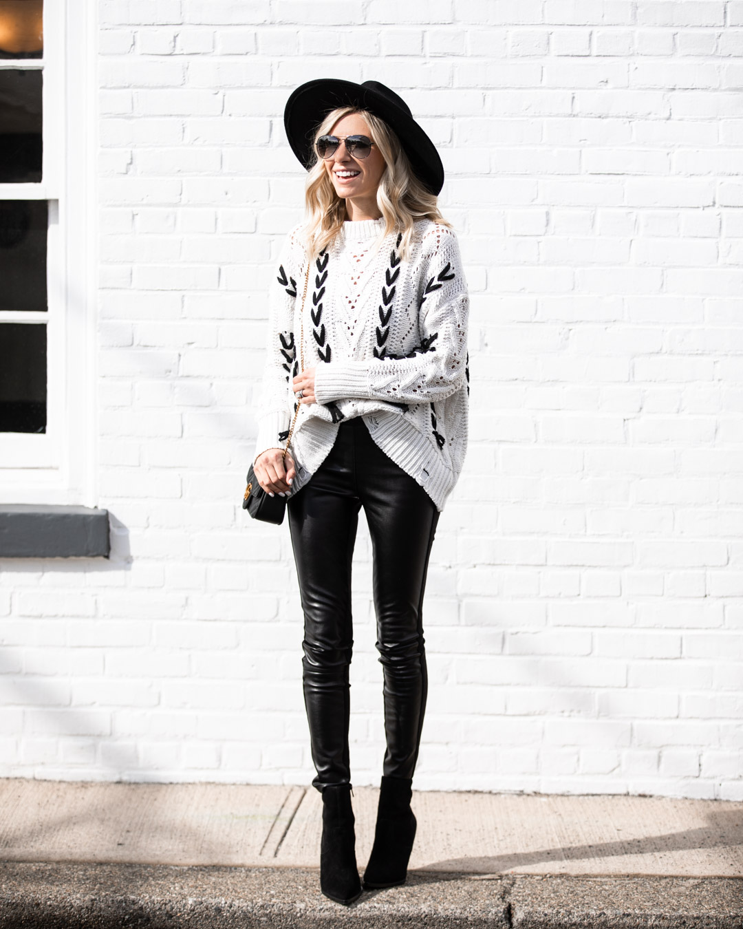 White sweater & black leather pants